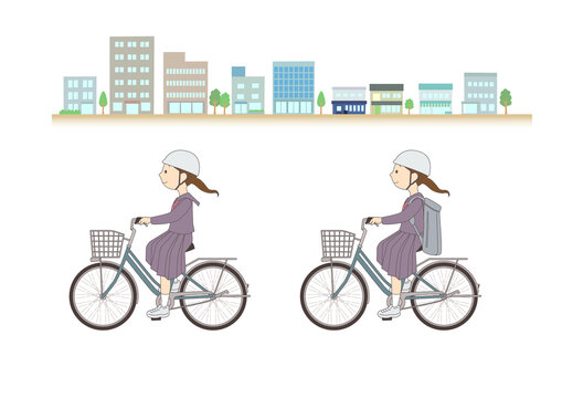 街並みを背に自転車に乗る女子学生