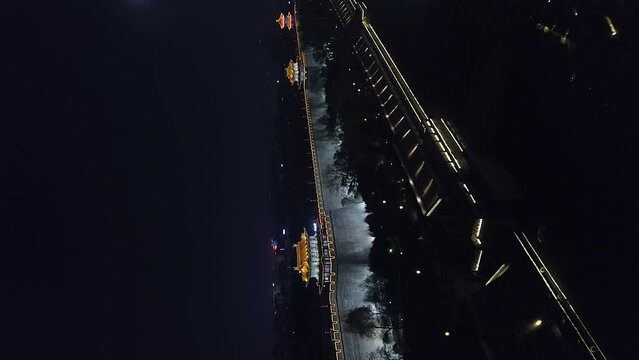 Vertical format night aerial to illuminated crenels on Xi'an city wall