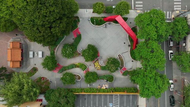 Lowering close up drone shot of Hing Hay Park in downtown Seattle.