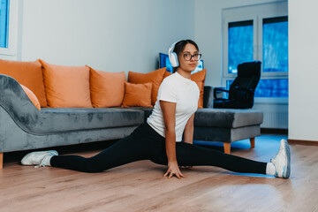 A woman stretching in her apartment during early morning after training , reflecting her dedication to a healthy lifestyle. This moment highlights the importance of regular exercise and self-care