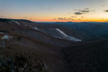 Aerial Drone View of West Virginia Snowshoe Mountain at Sunset with Some Snow