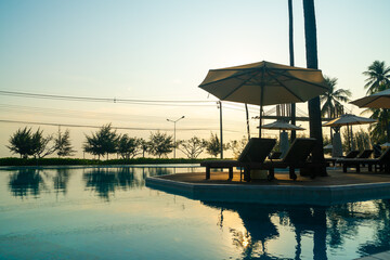 umbrella with bed pool around swimming pool with ocean sea background