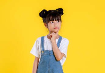 image  of  asian little girl posing on a yellow background - Powered by Adobe