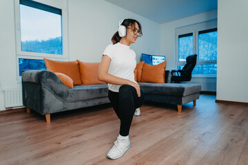 A woman stretching in her apartment during early morning after training , reflecting her dedication to a healthy lifestyle. This moment highlights the importance of regular exercise and self-care