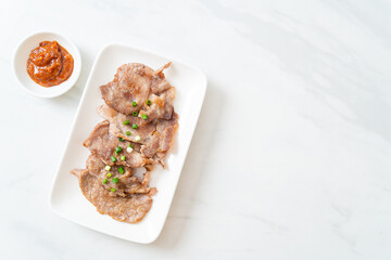 grilled pork neck sliced on plate