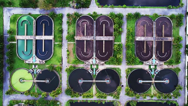 Aerial view High angle view Top down drone shot of the sewage treatment plant.The Solid contact clarifier tank type sludge recirculation in water treatment plant. Industrial wastewater treatment plant