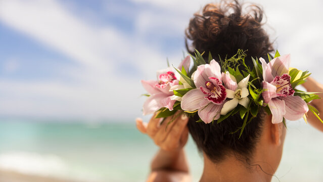 Woman making Hawaiian Lei and Hahu. Process of Handmade flower crown made from Hawaii flower Plumeria.