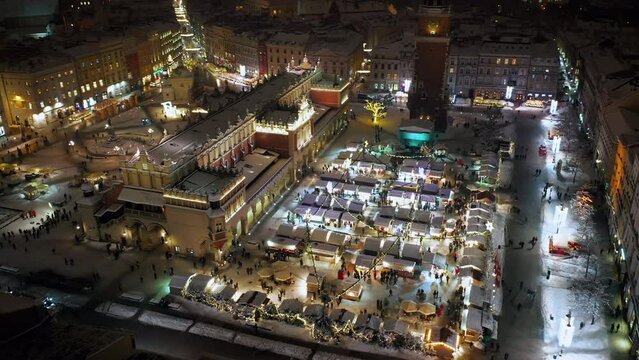 Christmas time on the Main Market Square (Christmas stalls, Saint Mary's Basilica, Sukiennice - Cloth Hall, Town Hall Tower) in Krakow, Poland