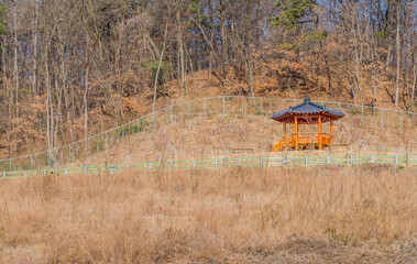 Oriental gazebo on rural hillside on sunny autumn day.