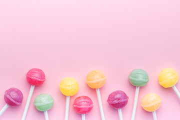 Sweet lollipops on pink background