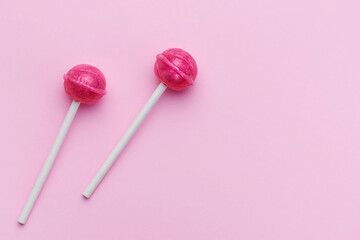 Sweet lollipops on pink background