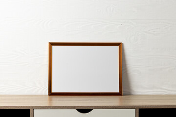 Brown empty frame with copy space on table against white wall