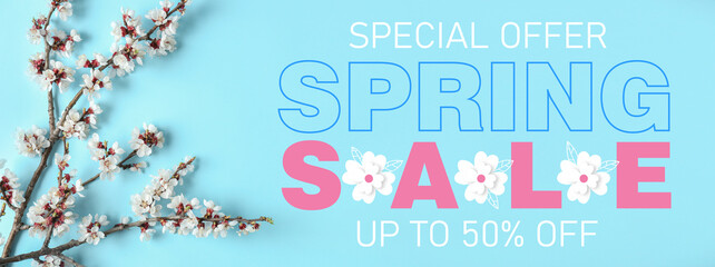 Beautiful blossoming tree branches on light blue background. Spring sale