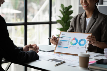 Accounting consultant, businesswoman meeting to discuss and clarify details on chart And data...