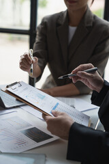 Team of business people working at office. Analyzing, discussing and recording financial budget results, investments, project plans, business operations based on graph documents. chart into laptop.