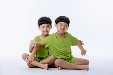 Fototapeta na wymiar Portrait of cute Asian twins boys. two little boys twins isolated on white background. twins boys fun together on white background
