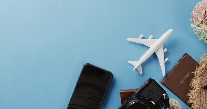Close up of white plane model, smartphone and copy space on blue background