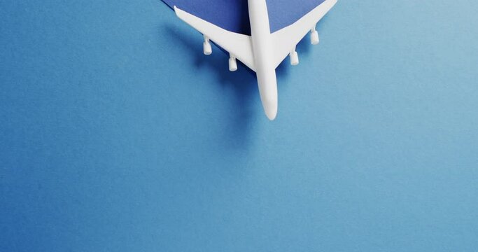 Close up of white airplane model and copy space on blue background