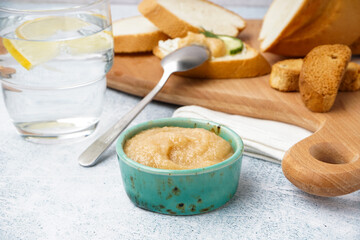 Bowl with caviar of capelin and delicious canape on grey background