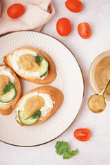 Delicious canapes with caviar of capelin on grey background