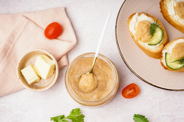 Jar with delicious caviar of capelin on grey background