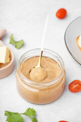 Jar with delicious caviar of capelin on grey background