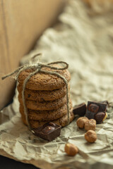 Cookies chocolate and nuts on a background of craft paper and wood