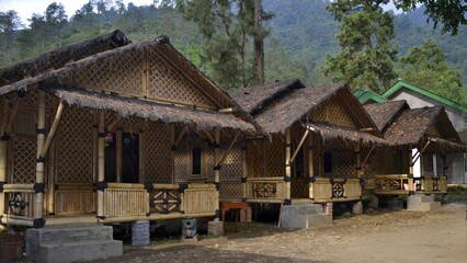 Fototapeta na wymiar wooden beautiful cottages in the middle of the forest shot in daytime in Indonesia