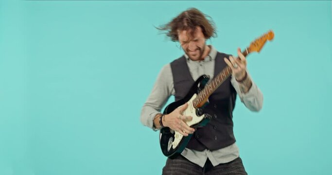Punk, music and guitar with man in studio for performance, crazy and concert. Metal, creative and entertainment with male and instrument isolated on blue background for dance, vintage and musician