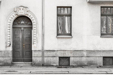 View of old building with wooden door and windows