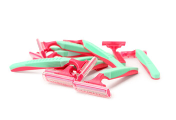 Heap of colorful safety razors on white background
