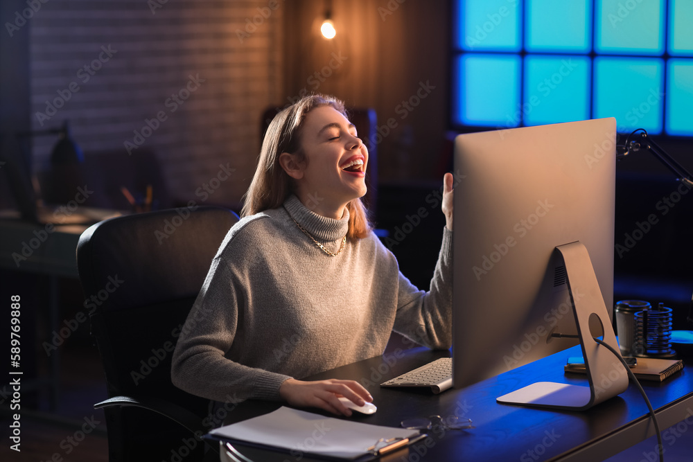 Poster happy female programmer working with computer in office at night