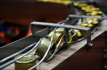 Canned food products on conveyor belt in distribution warehouse. parcels transportation system...