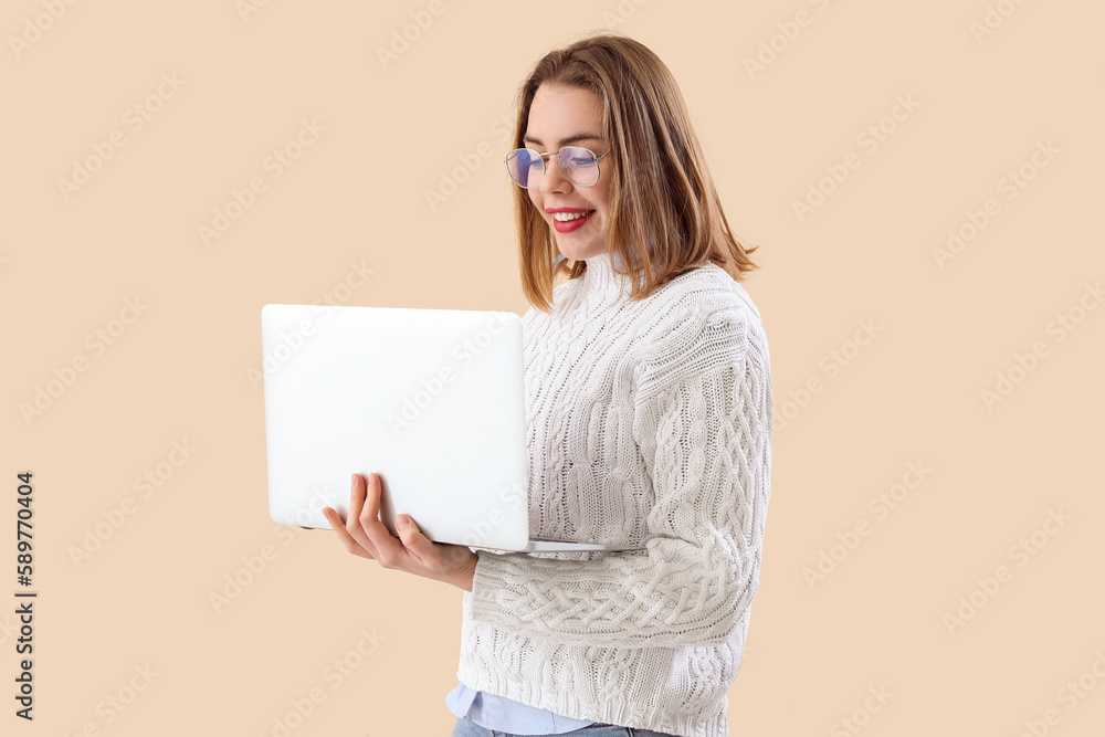 Poster female programmer working with laptop on beige background