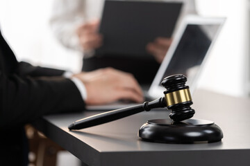 Focus gavel hammer for righteous and equality judgment with blur background of lawyer colleagues or...