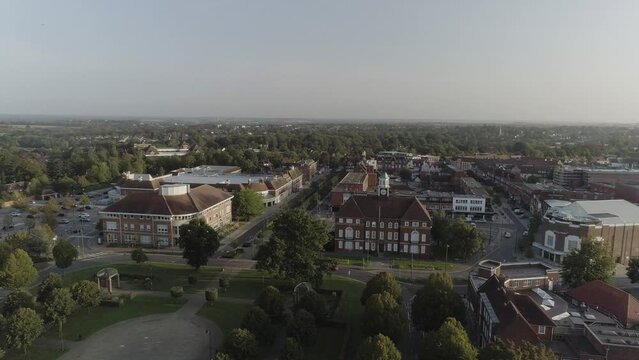 Drone shot of town centre and local park and lots of green trees with birds crossing the sky in Letchworth Garden City
