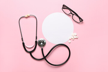 Blank card, stethoscope, pills and eyeglasses on pink background. Melanoma concept
