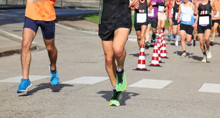 runners during the marathon on the city streets run in sneakers