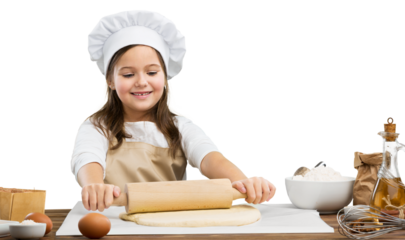 Happy child in chef costume stretch the dough