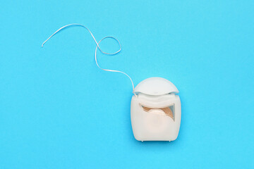 Case with dental floss on blue background