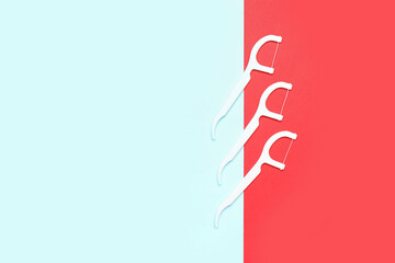 Floss toothpicks on red and blue background