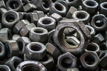 Old iron nuts close-up. Ironmongery. A selective focus.