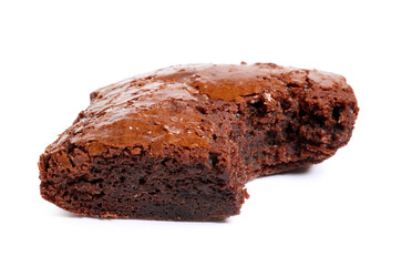 Piece of bitten chocolate brownie isolated on white background