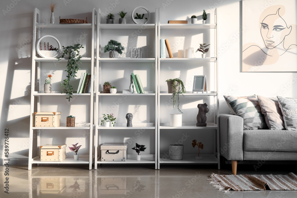 Sticker Interior of light living room with sofa, shelving units and artificial plants