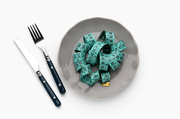 Table setting with measuring tape on light background