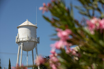 Afternoon sun shines on a historic downtown water tower of Elk Grove, California, USA.