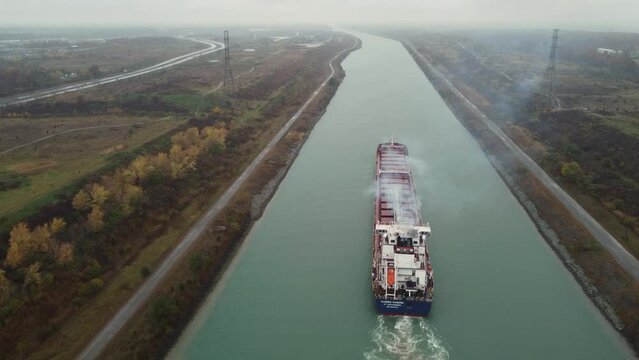 A fully laden container ship steams up Welland Canal in St Catharines Canada