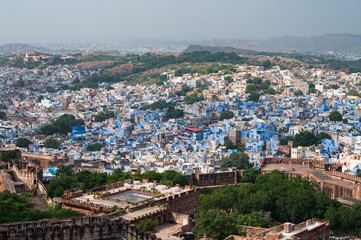 Fototapeta na wymiar Top view of famous Mehrangarh fort, Jodhpur city in the background, as seen from top of the fort, Jodhpur, Rajasthan, India. Mehrangarh Fort is UNESCO world heritage site popular worldwide.