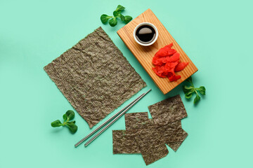 Composition with nori sheets, ginger and soy sauce on color background