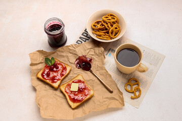 Tasty toasts with cranberry jam, cup of coffee and cookies on light background